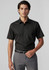 A short-sleeve button-up shirt in black, featuring a pocket, worn with tailored grey trousers.