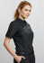 A black short sleeve button-up shirt with a sleek design and two chest pockets, worn by a model.