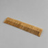 A bamboo comb in a natural wood finish, featuring teeth for detangling hair. It has a subtle branding logo.