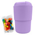 A reusable coffee cup in lavender with a ribbed design, accompanied by a packet of colourful jelly beans.