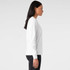 A long-sleeved white t-shirt displayed on a model from the side, featuring a subtle logo.