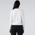 A white long-sleeve tee displayed from the back, featuring a logo on the neckline.