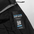 A black backpack with a tag highlighting its eco-friendly features and a logo, displaying the sustainable ethos of the product.