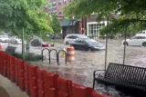 Mayim modular flood wall protecting a sidewalk from a flooded city intersection