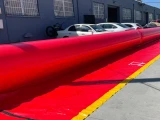 Serpent Inflatable Flood Barrier Tube protecting parked cars along a building