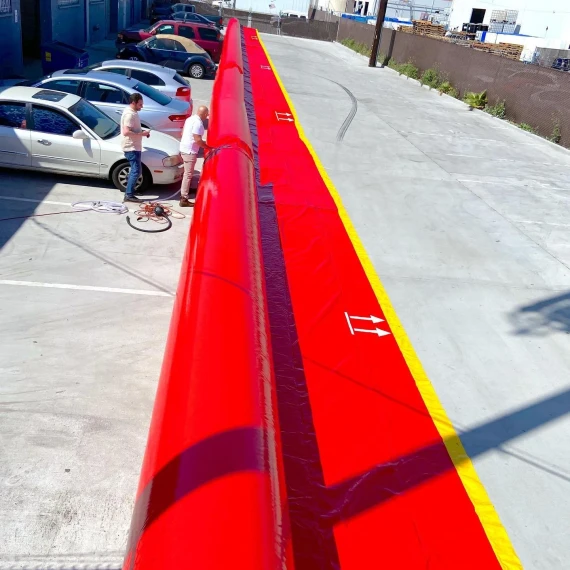 Serpent Inflatable Flood Barrier Tubes running the length of a parking lot