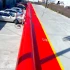 Serpent Inflatable Flood Barrier Tubes running the length of a parking lot