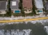 Guppy MAX Heavy-Duty Water-Filled Flood Barrier protecting a row of beachfront homes