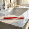 GUM 311 Classic Toothbrush – Compact Head, Soft 3-Row Bristles for Gentle Cleaning view of toothbrush on a bathroom sink