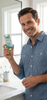 GUM Go-Betweens Proxabrush Wide Refills #614 being held up by a smiling man in a bathroom