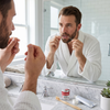 POH Classic Super Thin White 490 NoWax Dental Floss view of man flossing his teeth in a sunny bathroom