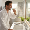 Oral-B Indicator 35 toothbrush a lifestyle photo of a man in a bathroom in a bathrobe brushing his teeth with the toothbrush