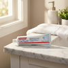 Colgate Gel-Kam 0.4% Stannous Fluoride Gel - Fruit and Berry Flavor - 4.3 oz Tube - At-Home Dental Care view of tube sitting on a marble sink in a bathroom.
