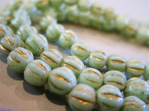 Opaque mint green gold wash 4mm melon Czech beads