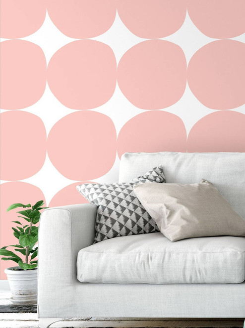 small sitting room with a white couch and  removable pink circle wall covering