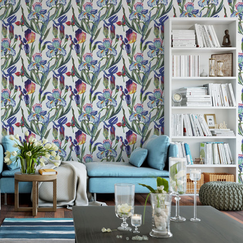 close up image of Iris floral watercolor wallpaper in a living room with two white book shelves, a couch and small coffee table