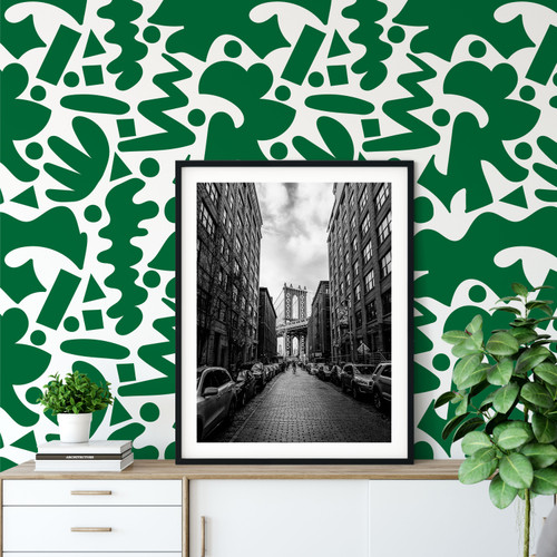 Green wallpaper and a large photo of buildings and a bridge on a credenza