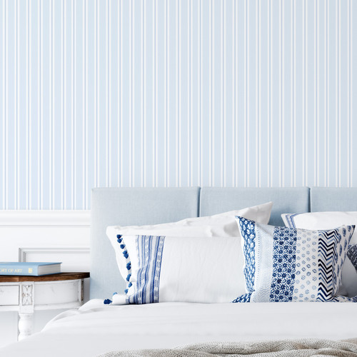 Blue striped wallpaper in a coastal themed bedroom