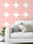 small sitting room with a white couch and  removable pink circle wall covering
