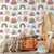 A child's bedroom with a wooden bed with rust colored bedding and colorful rainbow peel and stick wallpaper