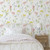A child's bedroom with wildflower wallpaper