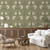 Living room wallpaper above a credenza in a room with a white couch and rattan chair