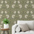 Close up of Pimpernel Wallpaper in a living room with a couch and end table with a plant