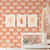 child's nursery with a crib in front of a wall with peach colored daisy flower wallpaper