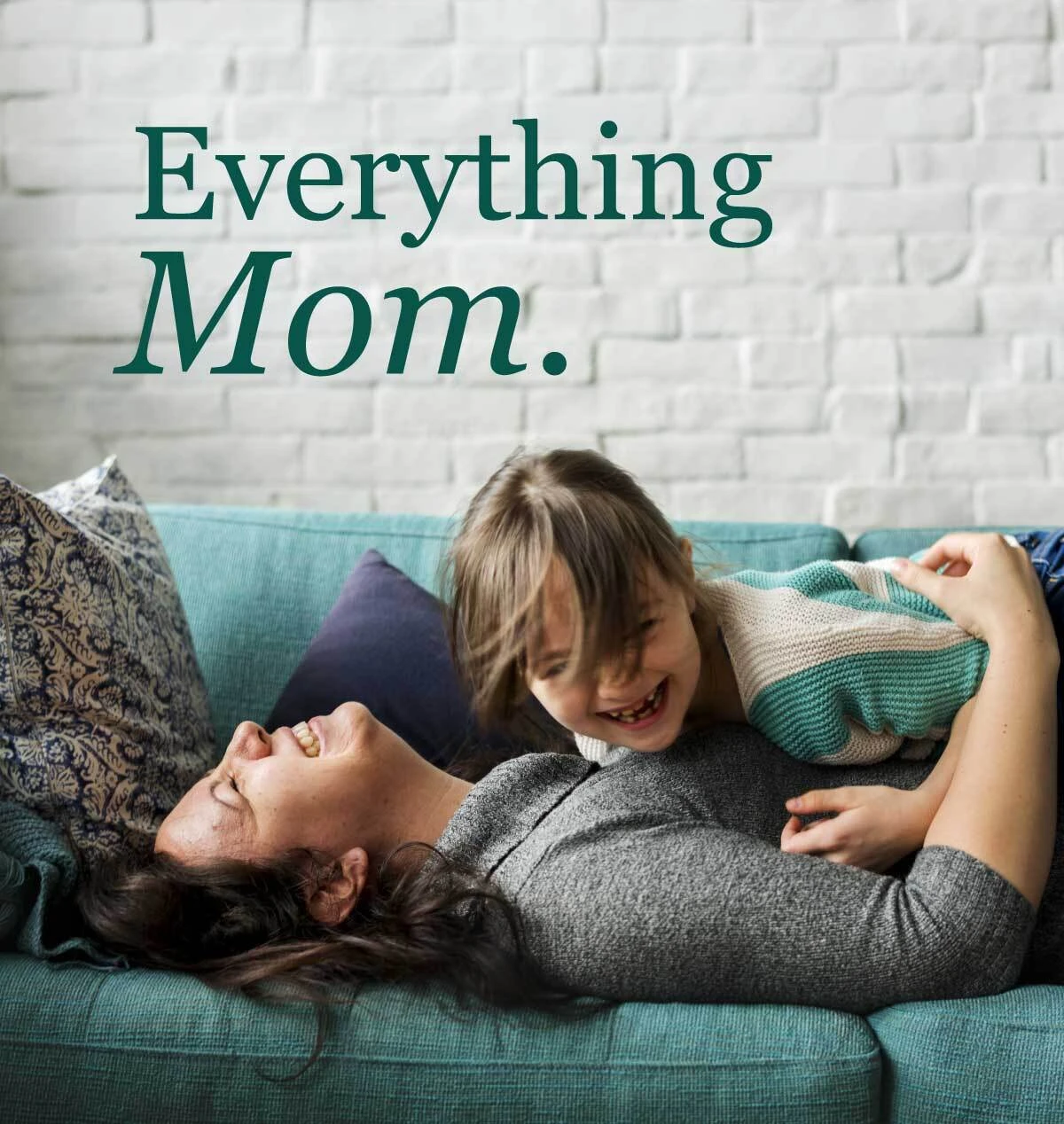 Mother laughing with child on couch