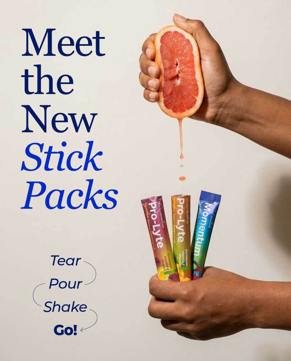 Momentum and Pro-Lyte stick packs arranged with grapefruit