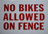 Sign NO Bikes Allowed ON Fence