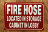 FIRE HOSE LOCATED IN STORAGE CABINET IN LOBBY COMPLIANCE SIGN