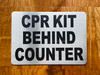 cpr-kit-behing-counter-double-sided-tape-sign.jpg