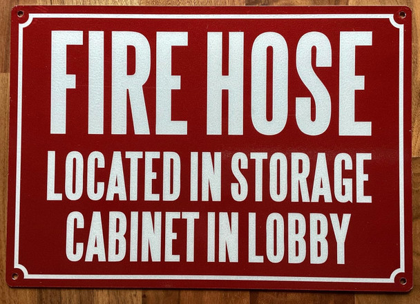 FIRE HOSE LOCATED IN STORAGE CABINET IN LOBBY SIGN