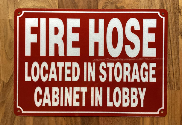 FIRE HOSE LOCATED IN STORAGE CABINET IN LOBBY SIGN