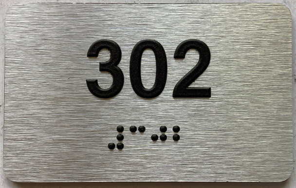 apartment number 302 sign