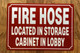FIRE HOSE LOCATED IN STORAGE CABINET IN LOBBY COMPLIANCE SIGN