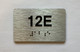 Apartment Number unit 12E Braille Sign