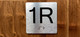 1R Elevator Jamb Plate Ada Sign