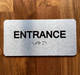 Entrance With Sign with Raised Letters Braille Sign