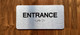 Entrance With Sign with Raised Letters Compliance Sign