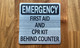 emergency-first-aid-cpr-kit-behing-counter-6-x-6-self-adhesive-metal-sign.jpg