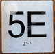 fd sign Apartment Number 5E with Braille and Raised Number