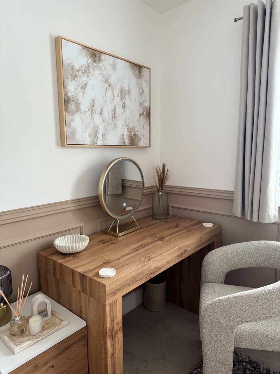 Elegant makeup desk area with half-wall wainscoting creating a sophisticated dressing space