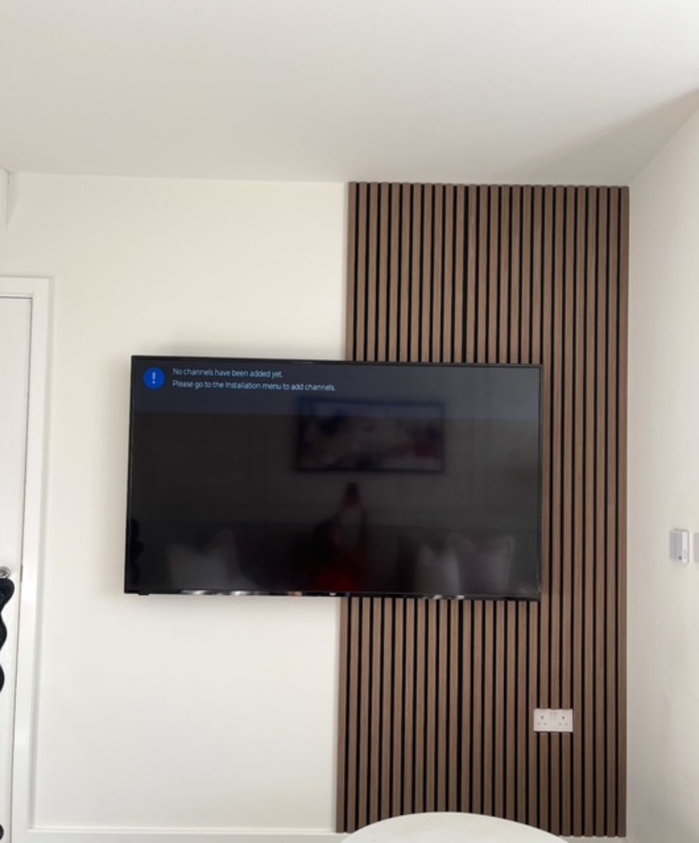 Modern living room with wooden slat wall panelling behind television