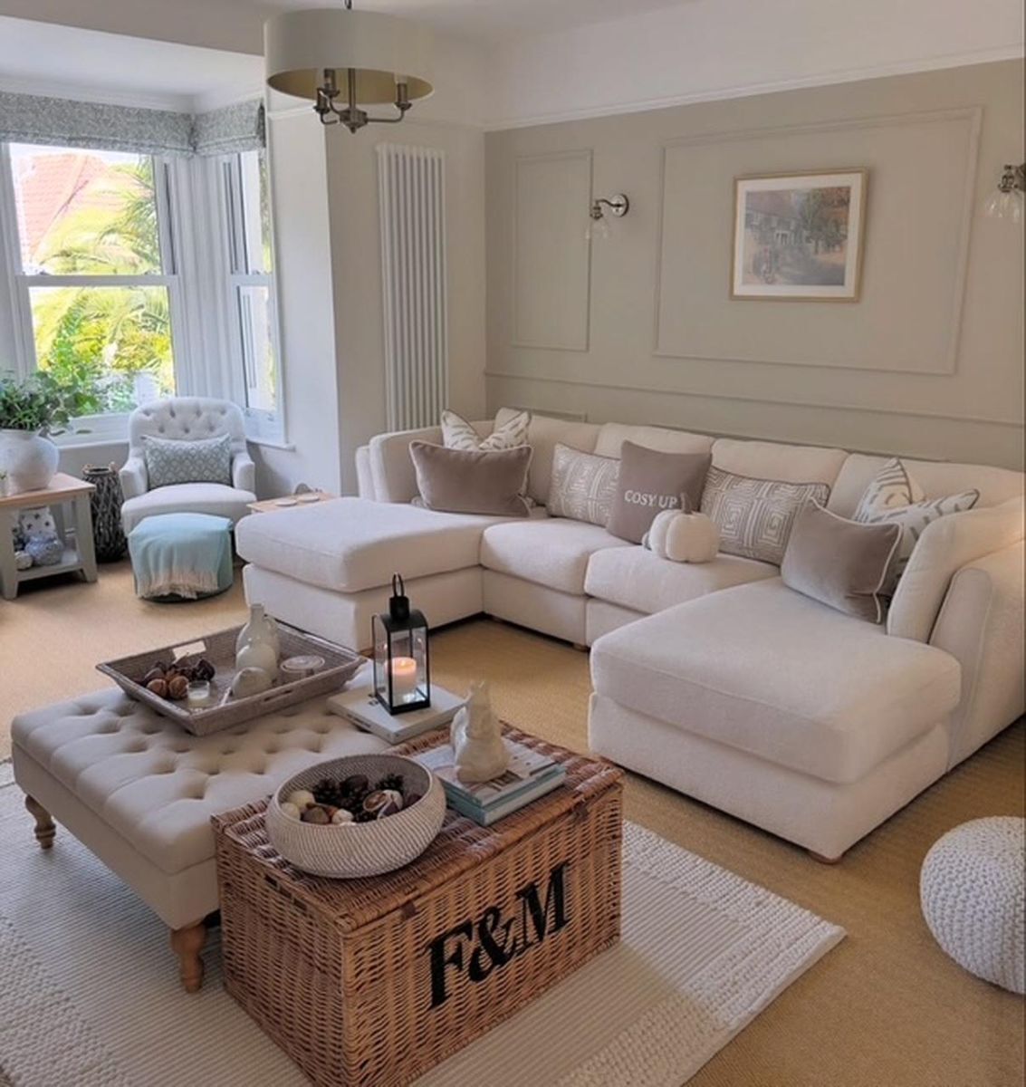 Living room with neutral palette panel moulding creating a sophisticated full wall accent feature