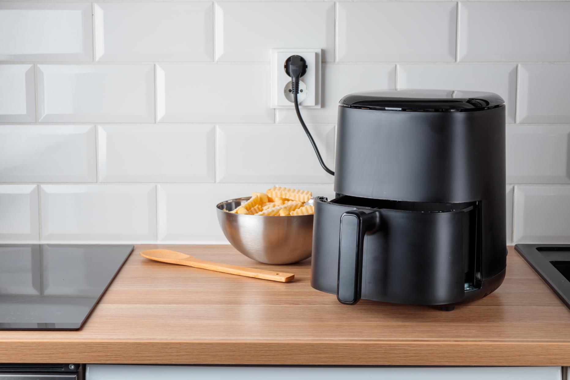 Air fryer with electrical socket and white subway tile panels