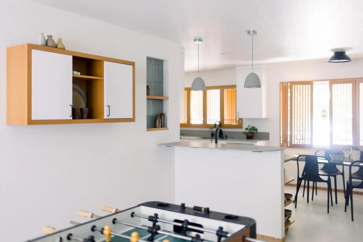After renovation: Full view of transformed Japandi kitchen with open layout, natural materials and minimalist design