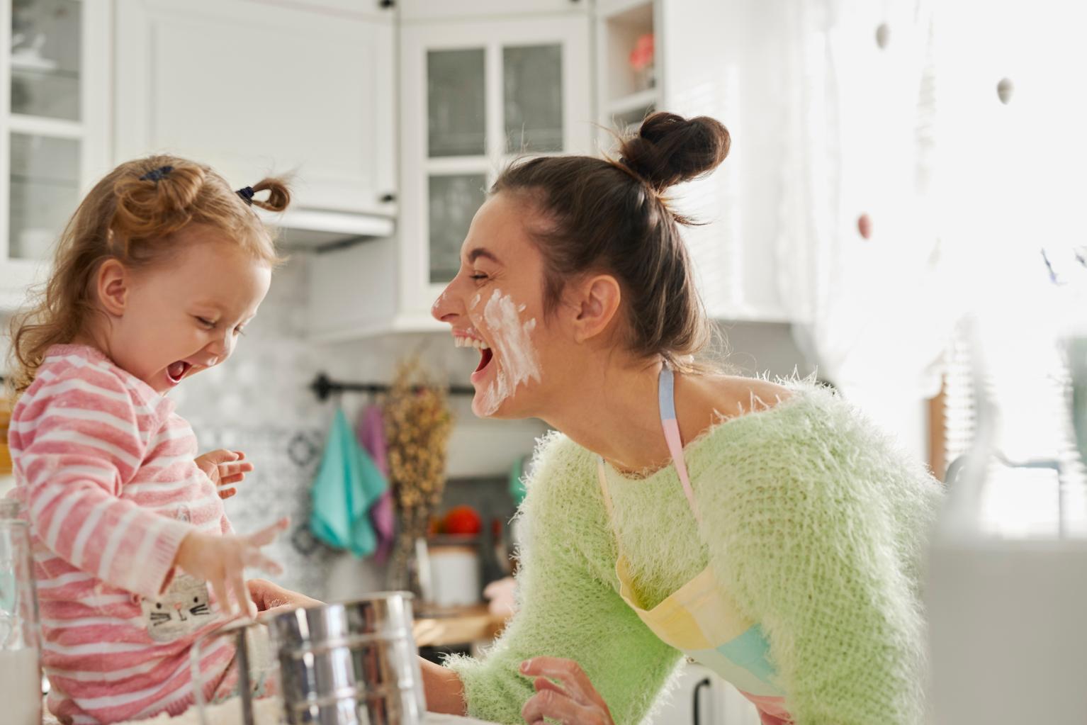 Family baking together with flour on faces