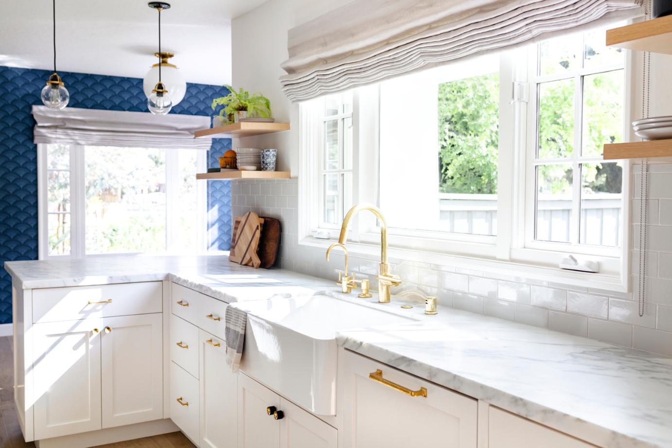 Light grey subway tiles with gold tap